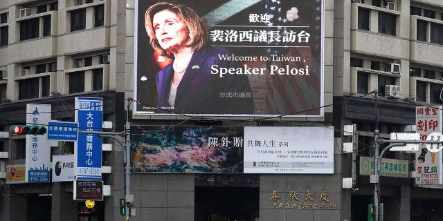 People walk past a billboard welcoming U.S. House Speaker Nancy Pelosi, in Taipei, Taiwan, Aug 3, 2022.