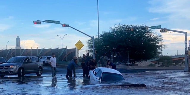 Firefighters and local residents in El Paso are seen tending to the stricken passenger.