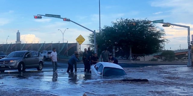 Firefighters and local residents in El Paso are seen tending to the stricken passenger.