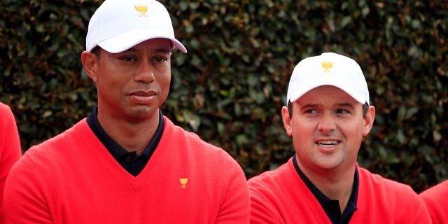 Playing Captain Tiger Woods of the United States team and Patrick Reed of the United States team look on during their team photo ahead of the 2019 Presidents Cup at Royal Melbourne Golf Course on Dec. 11, 2019, in Melbourne, Australia