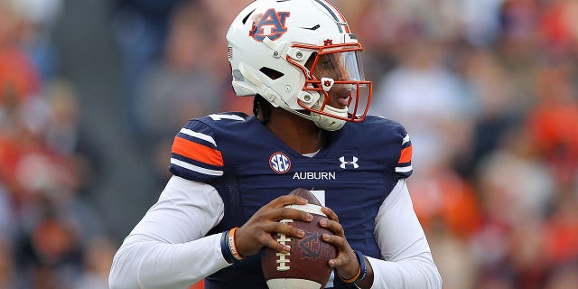 TJ Finley, do Auburn Tigers, parece passar contra o Alabama Crimson Tide durante o primeiro tempo no Jordan-Hare Stadium, em 27 de novembro de 2021, em Auburn, Alabama.