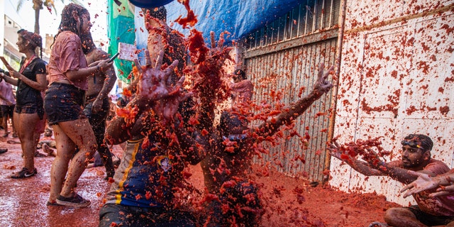 The world's largest food fight festival, La Tomatina, consists of throwing overripe and low-quality tomatoes at each other. (Zowy Voeten/Getty Images)