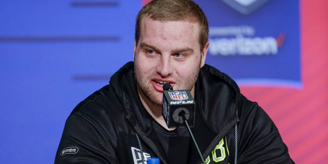 Trevor Penning #OL38 of the Northern Iowa Panthers speaks to reporters during the NFL Draft Combine at the Indiana Convention Center on March 3, 2022 in Indianapolis, Indiana.