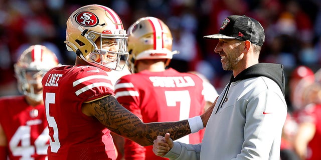 Trey Lance (5) of the San Francisco 49ers and head coach Kyle Shanahan of the San Francisco 49ers talk before a game against the Houston Texans at Levi's Stadium on January 2, 2022 in Santa Clara, California.