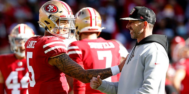 Trey Lance (5) of the San Francisco 49ers and head coach Kyle Shanahan of the San Francisco 49ers talk before a game against the Houston Texans at Levi's Stadium on January 2, 2022 in Santa Clara, California.