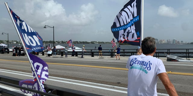 Floridians wave flags supporting Donald Trump after the FBI raided the former president's Palm Beach home.