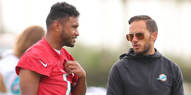 Miami Dolphins head coach Mike McDaniel (right) speaks with Tua Tagovailoa during training camp at the Baptiste Health Training Complex in Miami Gardens, Florida, July 27, 2022.
