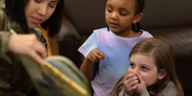 Senior Airman Paweena Vennum reads to children March 23, 2022, on Scott Air Force Base, Illinois.