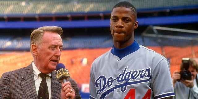 Darryl Strawberry #44 of the Los Angeles Dodgers was interviewed by Vince Scully before the start of a Major League Baseball game against the New York Mets circa 1991 at Shea Stadium in the Queens section of New York City.  Strawberry played for the Dodgers from 1991 to 1993.
