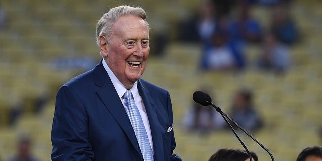 Retired Dodgers broadcaster Vin Scully, left, speaks during a pre-game ceremony honoring broadcaster Jaime Jarrin as he presents him with the Dodger Stadium Ring of Honor at Dodger Stadium on September 2, 2018 in Los Angeles, California. 