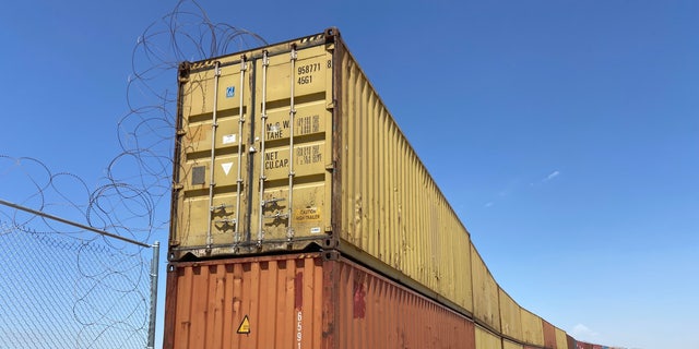 Construction to place these shipping containers in gaps in the border wall began Friday, Aug. 12, in Yuma, Arizona.