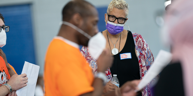 Linda K. Harllee Harper, Director, Gun Violence Prevention listens to a team present their ideas. Students in the LEAD Up! Program at the Washington, D.C., DOC have been challenged to come up with solutions to reduce gun violence in the District. A "think science fair" was held on Wednesday, August 3, 2022 for the teams to present their ideas to an audience.
