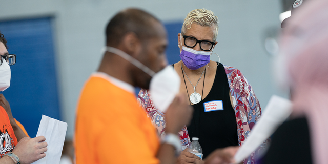 Linda K. Harllee Harper, Director, Gun Violence Prevention listens to a team present their ideas. Students in the LEAD Up! Program at the Washington, D.C., DOC have been challenged to come up with solutions to reduce gun violence in the District. A "think science fair" was held on Wednesday, August 3, 2022 for the teams to present their ideas to an audience.