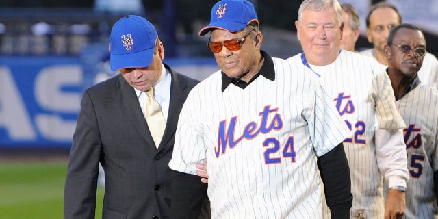 Former New York Mets players Willie Mays and Ray Knight walk onto the field after the game against the Florida Marlins to commemorate the last regular season baseball game ever played in Shea Stadium on September 28, 2008, in the Flushing neighborhood of the Queens borough of New York City.