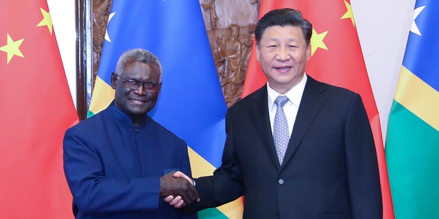 Chinese President Xi Jinping meets with Solomon Islands' Prime Minister Manasseh Sogavare in Beijing, Oct. 9, 2019.