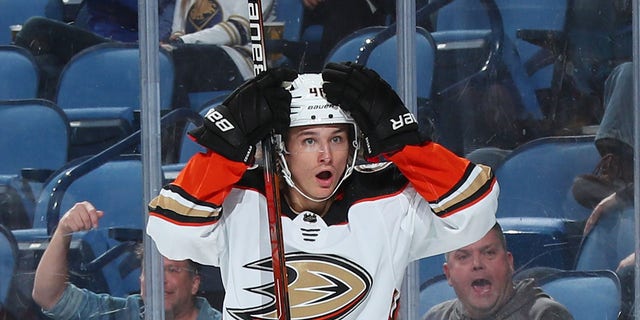 Trevor Zegras of the Anaheim Ducks reacts to his behind-the-net assist on a second-period goal against the Buffalo Sabers at KeyBank Center in Buffalo, New York, on Dec.  7, 2021.