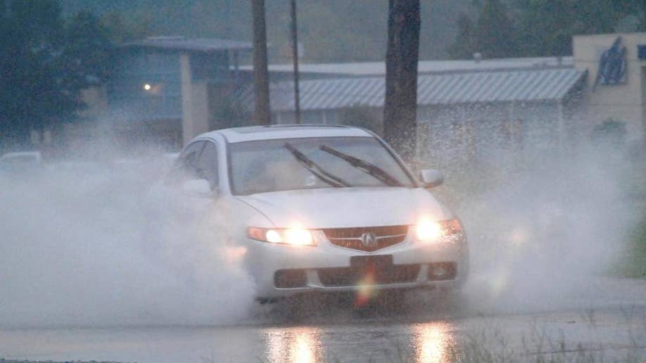 Car drives through flood