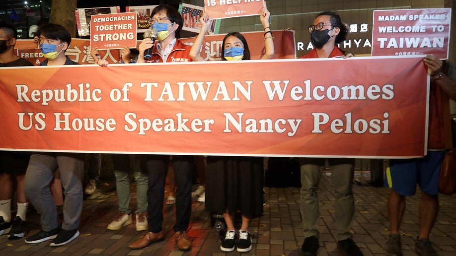 Supporters hold banner to welcome Nancy Pelosi visit to Taiwan