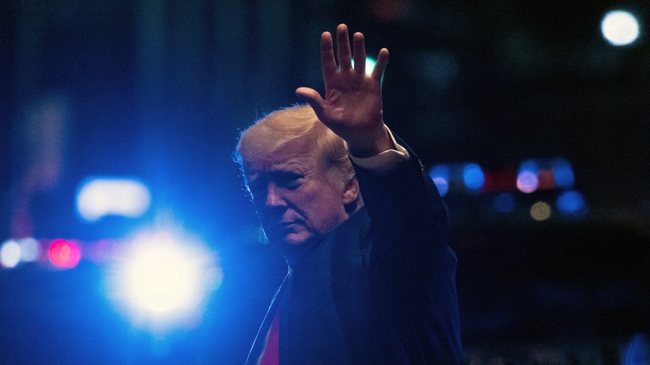 Donald Trump waves as he arrives back at Trump Tower in NYC