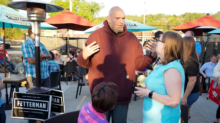 John Fetterman speaks with guests at an event