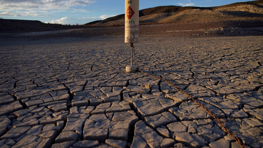 A buoy sits high and dry on cracked earth previously under the waters of Lake Mead