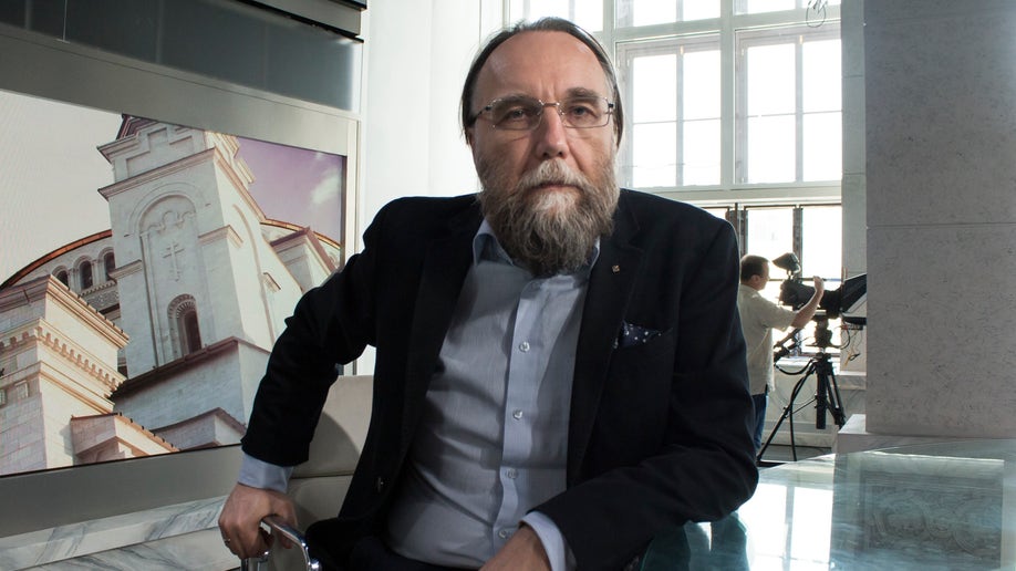 Alexander Dugin sitting in a chair for TV interview