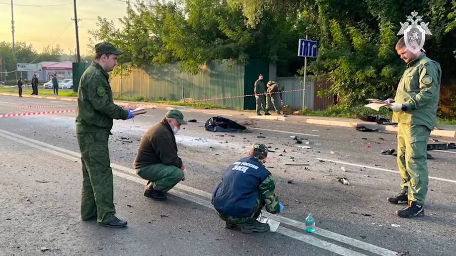 Investigators looking at the scene where a car bomb killed Daria Dugina