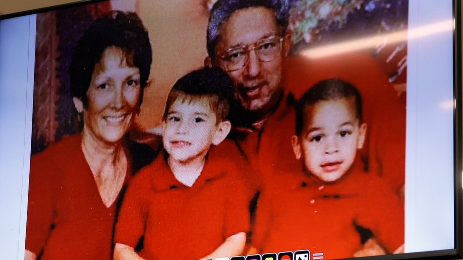 An undated photograph of the Cruz family is shown in the courtroom.