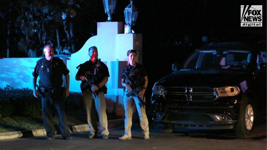 Men with guns stand outside Mar-a-Lago