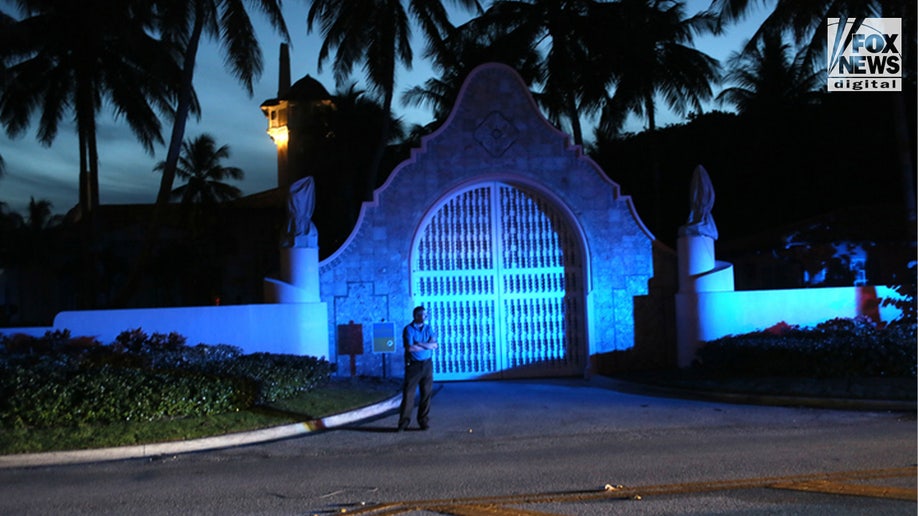 A guard is seen outside the gates of Mar-a-Lago