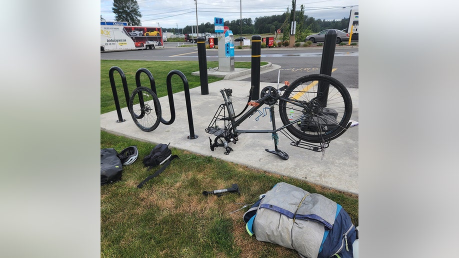 Barnes' upside down bicycle while he changes a tire