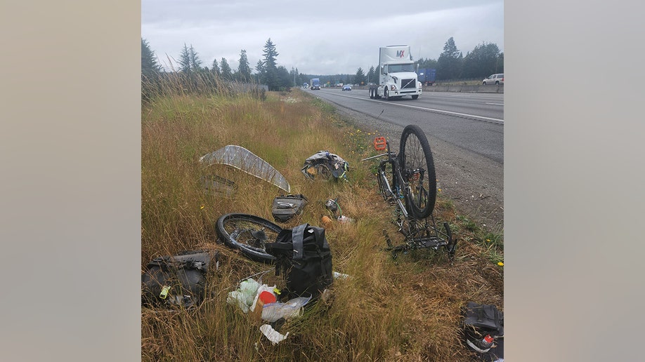 Barnes changing a tire by the interstate