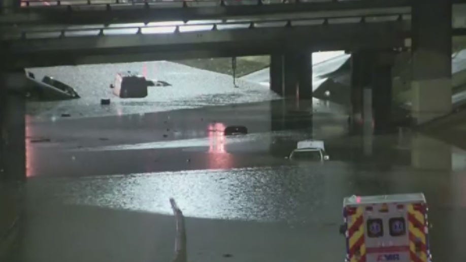 cars stranded in high water under overpass