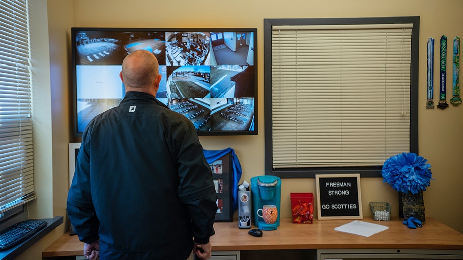 A security officer looking at a screen in Freeman High School