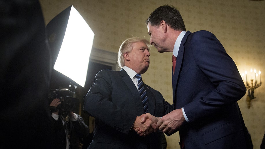 Donald Trump shaking hands with James Comey