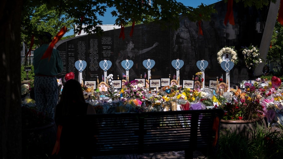 Memorials are placed near the scene of a shooting at a Fourth of July parade, on July 7, 2022 in Highland Park, Illinois. Authorities have charged Robert 
