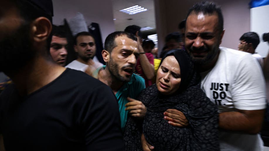 Palestinians react at a hospital in Jabalia 