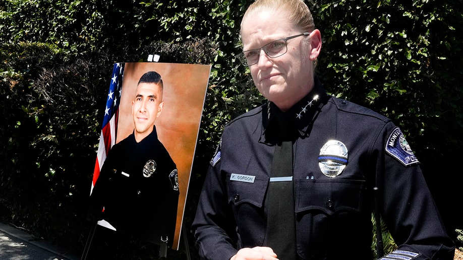 Monterey Park Chief of Police Kelly Gordon with a photo of Officer Gardiel Solorio