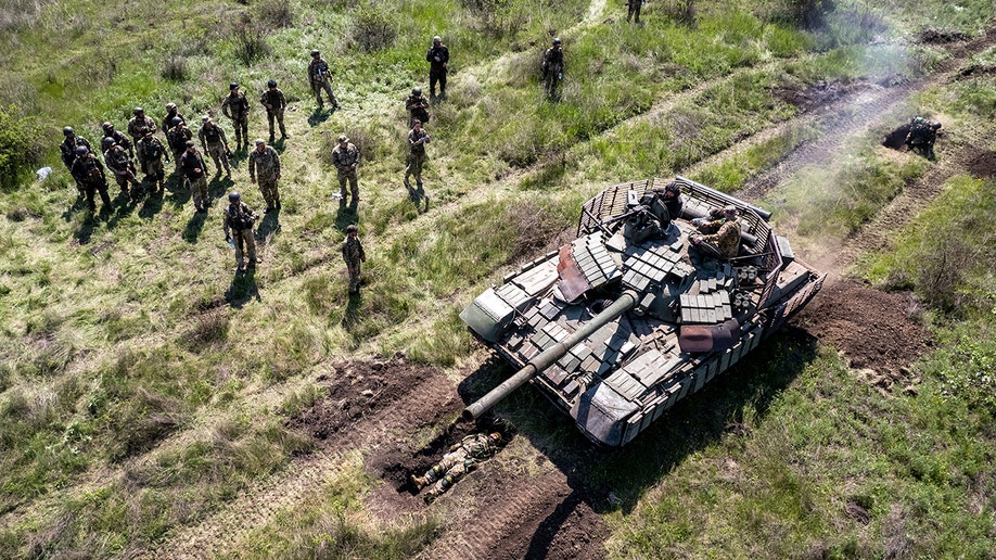 Ukrainian soldiers near a tank