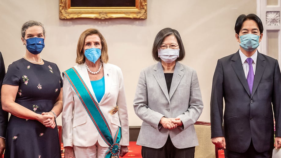 Speaker of the House Of Representatives Nancy Pelosi (D-CA), center left, poses for photographs after receiving the Order of Propitious Clouds with Special Grand Cordon, Taiwan’s highest civilian honor