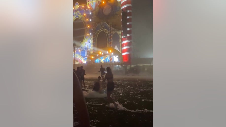 Music festival goers evacuate after the stage collapsed