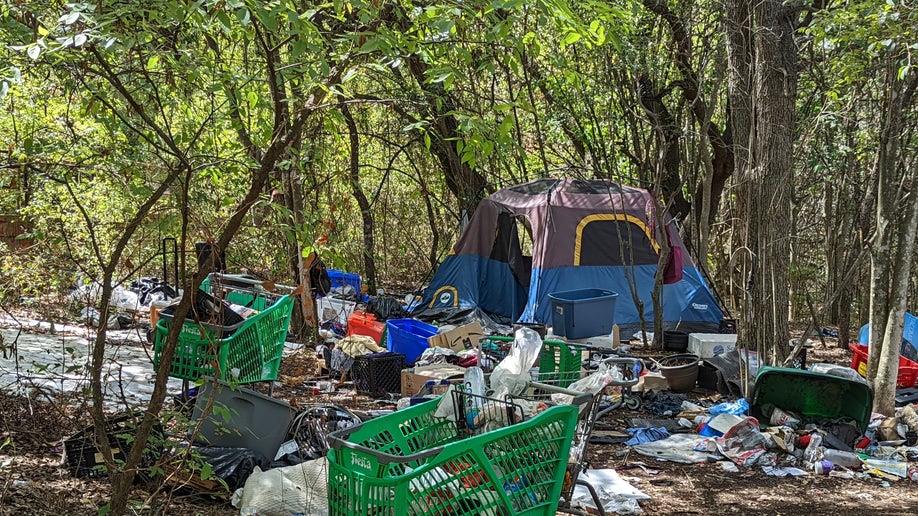 Homeless encampment littered with trash