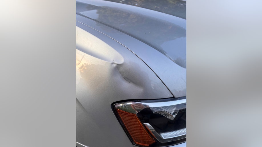 Denting on Timothy Reynold's car near a headlight
