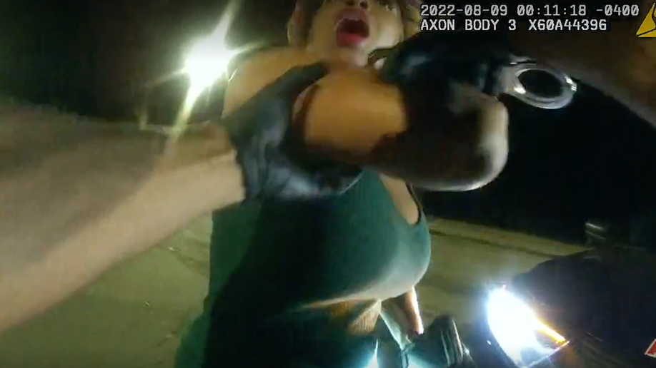 Screen shot of body cam footage shows a woman pulling her arm away from an Atlanta police officer during an arrest