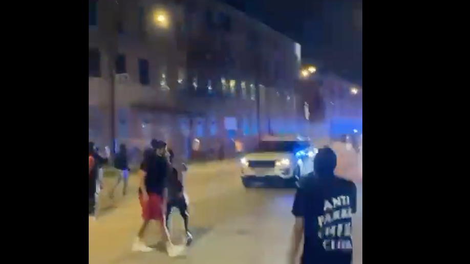 Screen shot from video shows people approaching a Chicago police car that was trying to disperse the crowd
