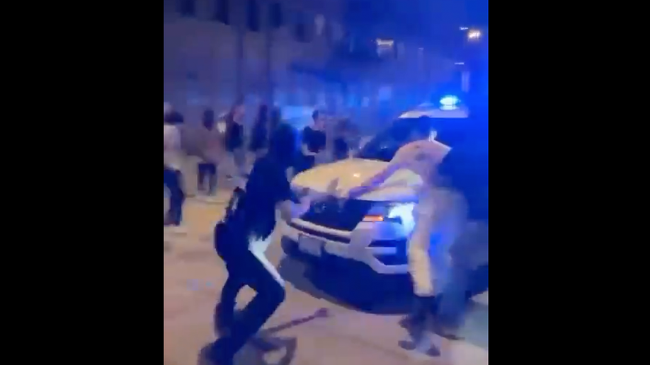 Screen shot from video shows people hitting Chicago Police Department vehicle that was trying to disperse crowd