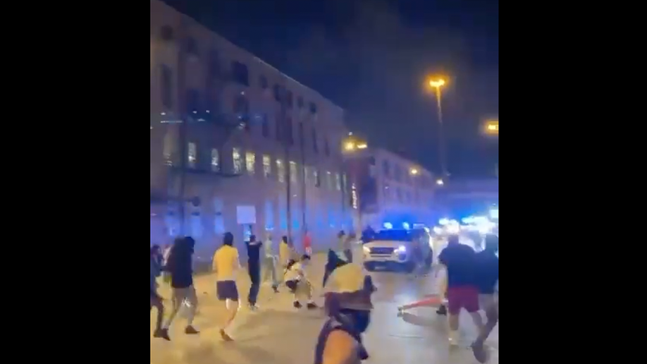 Screen shot from video shows Chicago crowd on street attempting to damage police vehicle