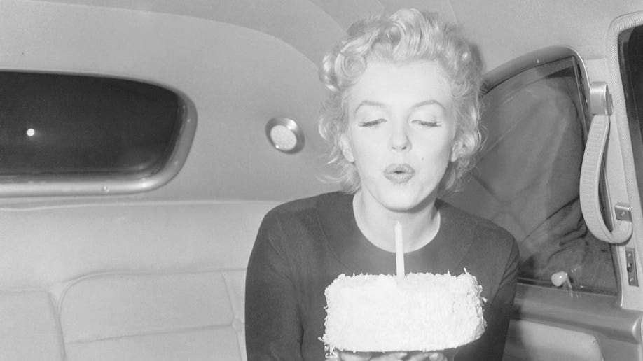 Marilyn Monroe, blowing out her 30th birthday candles on June 1, 1956. 