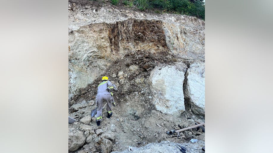 worker digging at construction site