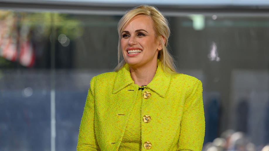 Rebel Wilson in a bright green suit